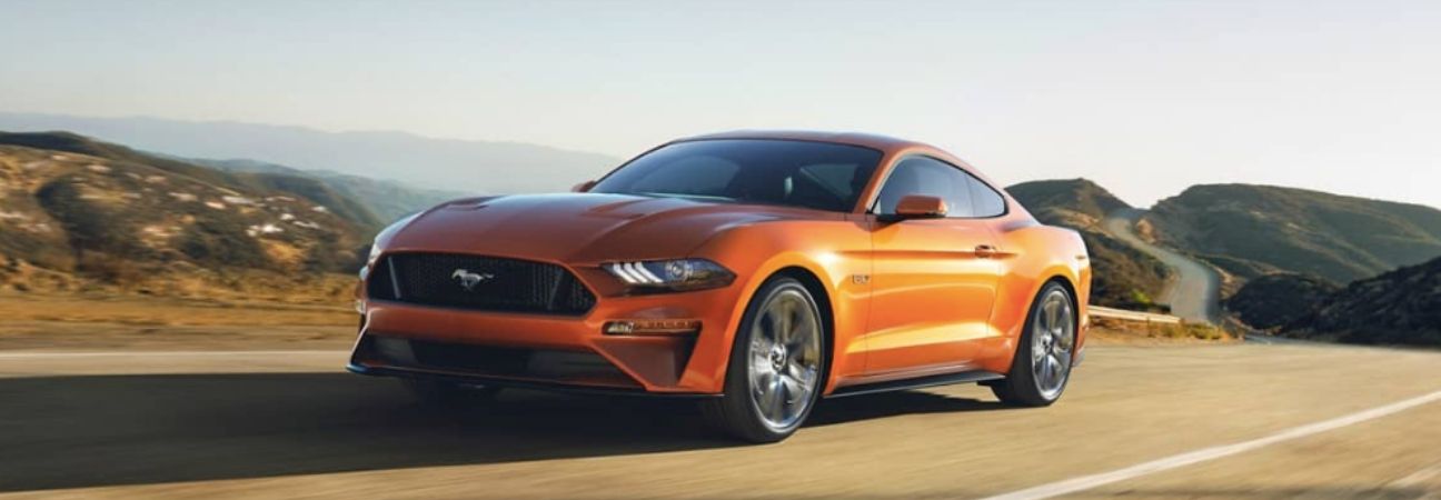 2019 Ford Mustang driving through the mountains on the highway